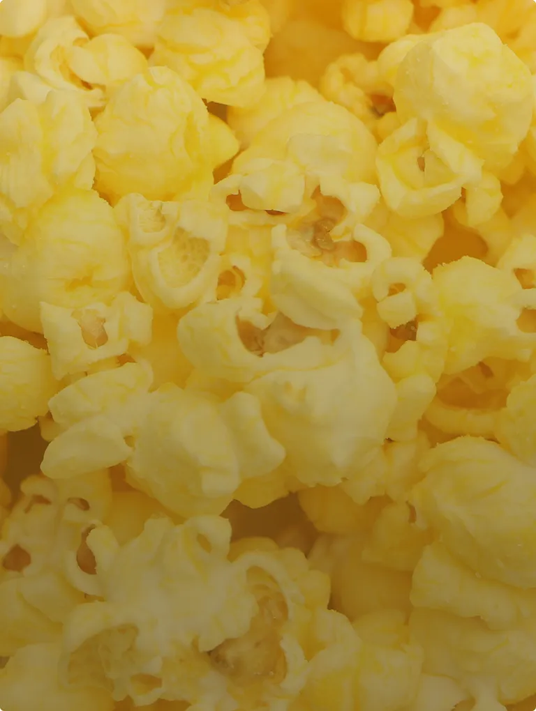 Jelly Belly Buttered Popcorn jelly bean closeup — golden yellow speckled gourmet bean
